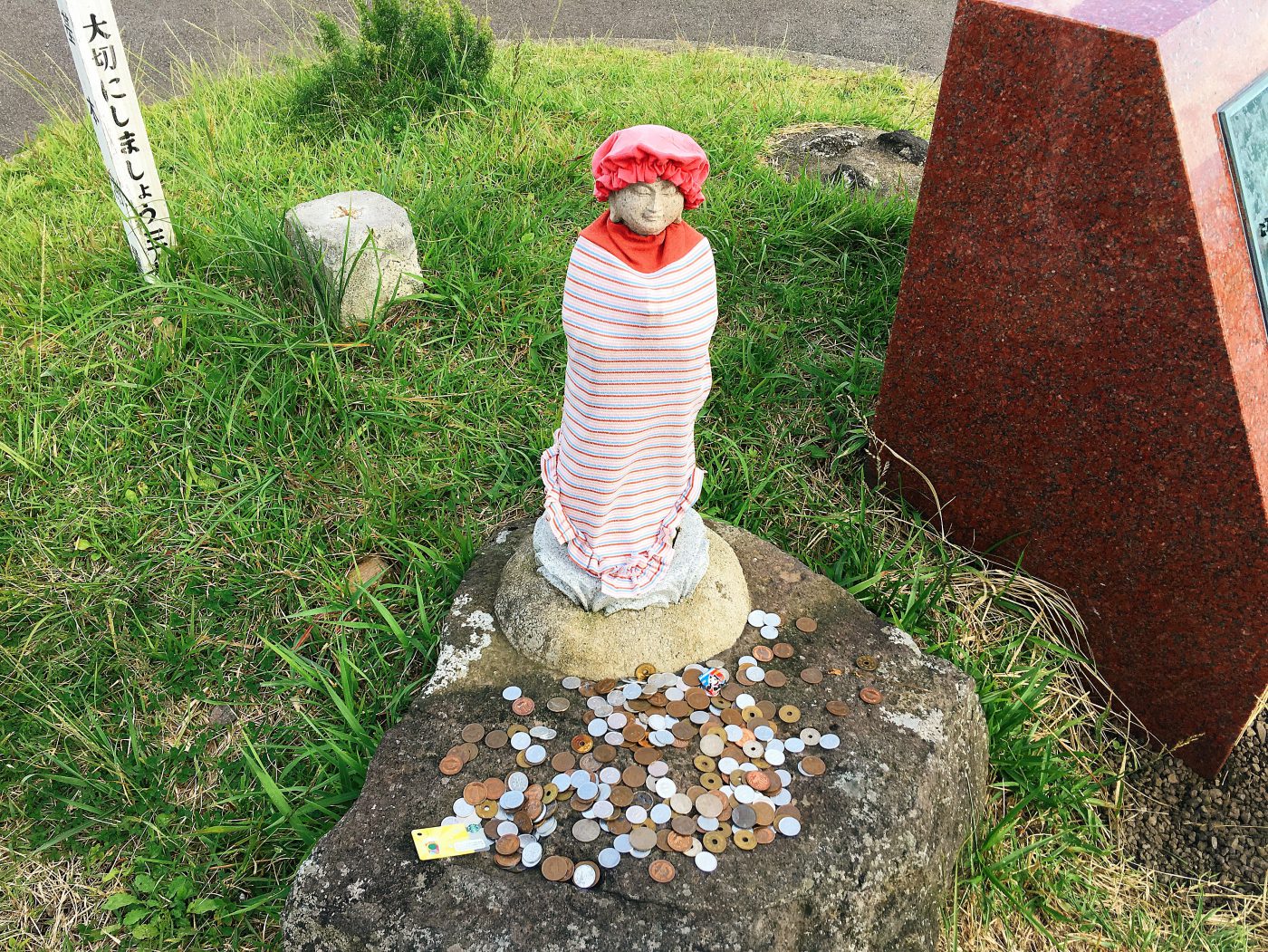 A little shrine with coin offerings