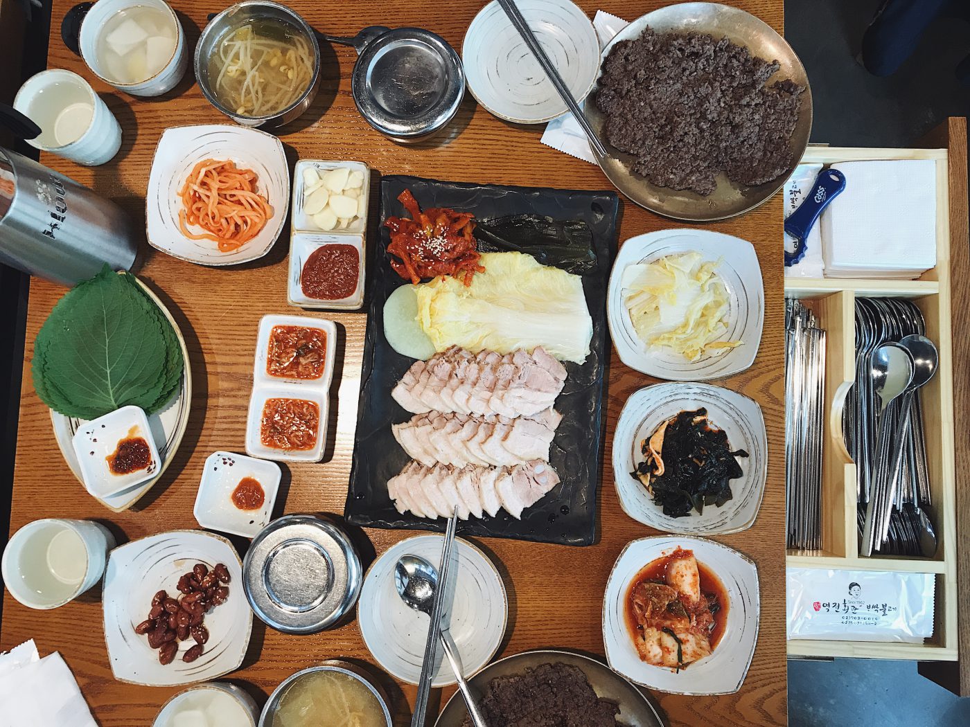 The spread at Yukjeon Hoekwan with Bossam in the middle. I love how the cutlery is hidden in a drawer in Korean restaurants!