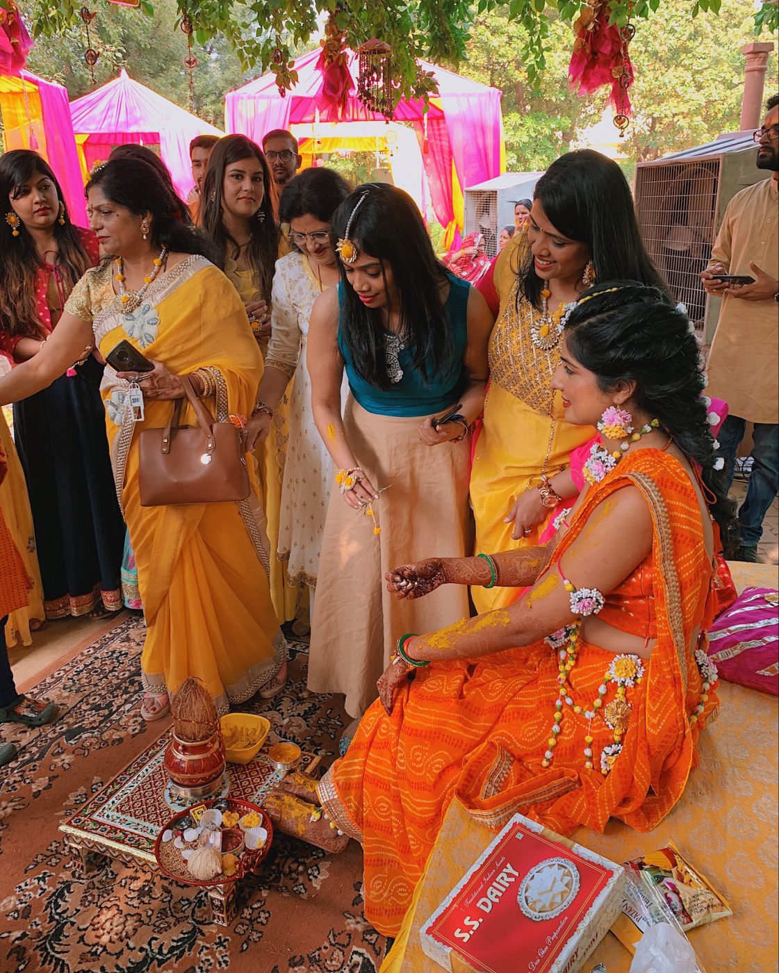 Bride getting turmeric paste on her hands
